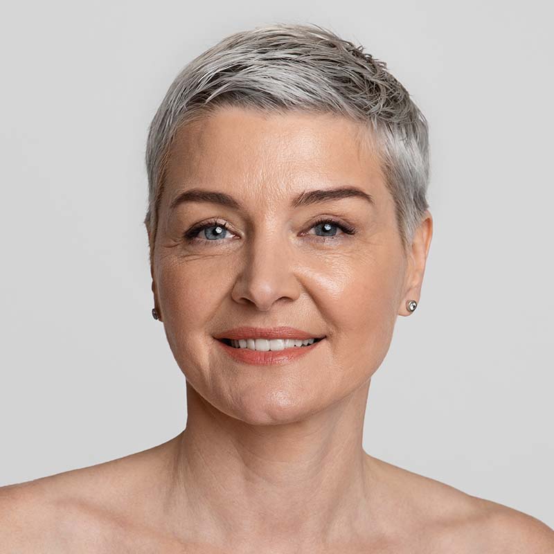 Beauty portrait of younger-looking middle aged woman with short haircut